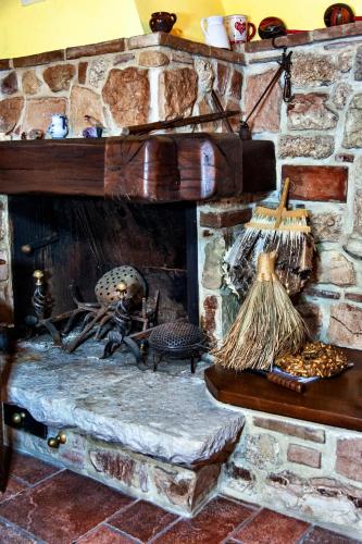 a stone fireplace with skeletons and other items at Rustico dell'Aia d'alto in Fabriano