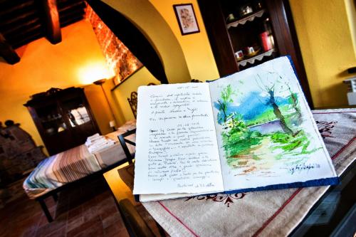 two pieces of paper on a table in a room at Rustico dell'Aia d'alto in Fabriano