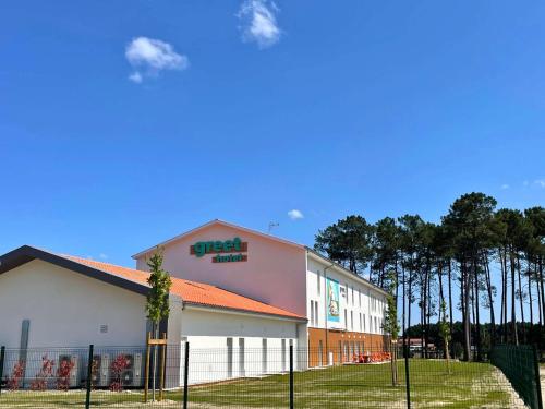 a building with a fence in front of it at greet hotel Castets Coeur des Landes in Castets