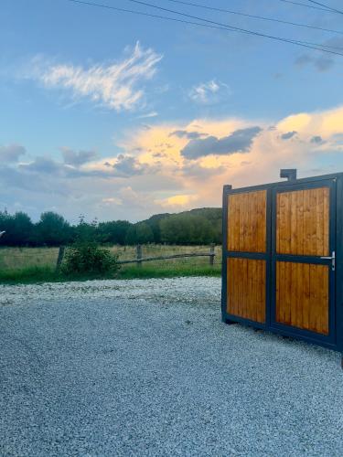 a wooden door on the side of a field at Peak Nest Rasnov in Râşnov