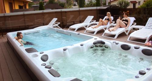 a group of people sitting in chairs around a hot tub at Triumph in Skhidnitsa