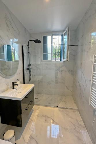 a white bathroom with a sink and a shower at Cozy Paris Gateway Apartments Groups with free parking in Vitry-sur-Seine