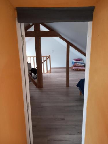 a hallway leading to a room with an attic at Via Lactéa in Saint-Goussaud