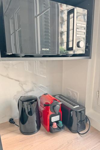a kitchen counter with a toaster and a toaster and a toaster at Cozy Paris Gateway Apartments Groups with free parking in Vitry-sur-Seine