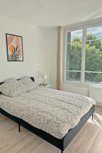 a bedroom with a bed and a large window at Cozy Paris Gateway Apartments Groups with free parking in Vitry-sur-Seine