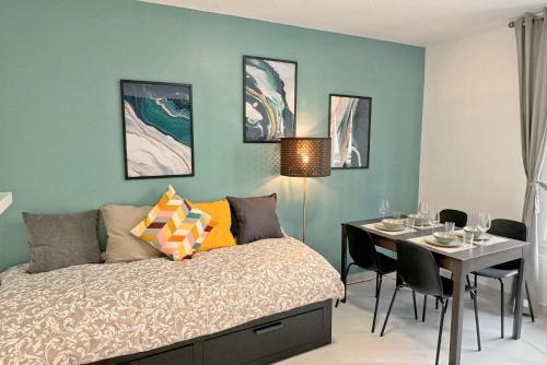 a bedroom with a bed and a table with chairs at Cozy Paris Gateway Apartments Groups with free parking in Vitry-sur-Seine