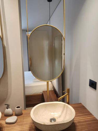 a bathroom with a sink and a mirror at Hotel Summer Dream in Dhërmi