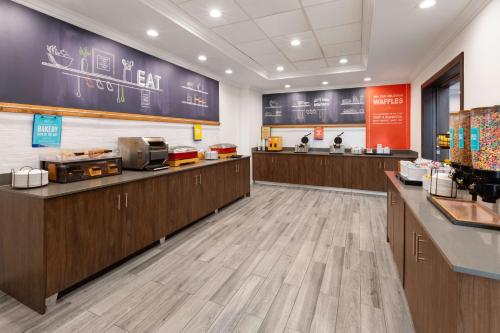 a fast food restaurant with wooden counters and a large wall at Hampton Inn & Suites Saginaw in Saginaw