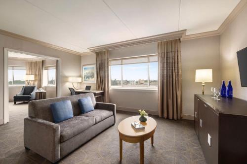 a living room with a couch and a table at Hilton Philadelphia City Avenue in Philadelphia