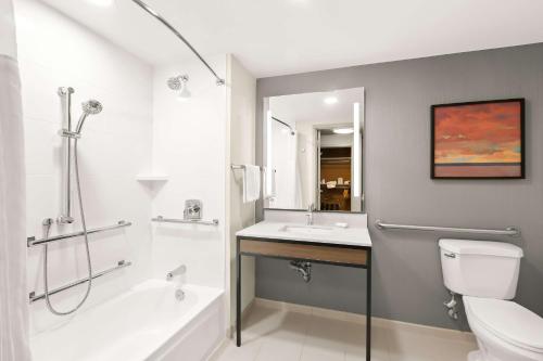 a bathroom with a shower toilet and a sink at Hilton Garden Inn San Mateo in San Mateo