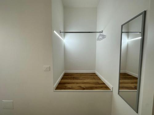 a bathroom with a mirror and a walk in shower at Hary Home in Brindisi