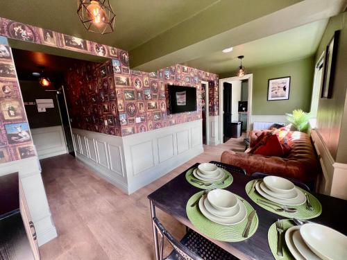 a living room with a table with plates on it at Stylish Flat With Stunning Views in Worcester