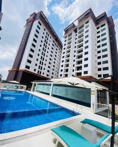a swimming pool in front of two tall buildings at Cosy luxurious siayapark apartments in Nairobi