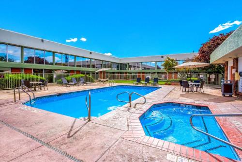 a swimming pool in front of a building at Clarion Inn Grand Junction Airport in Grand Junction