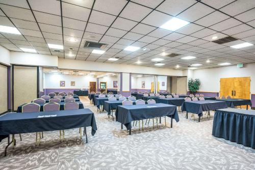 a banquet hall with blue tables and chairs at Clarion Inn Grand Junction Airport in Grand Junction