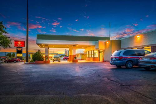 a gas station with a car parked in a parking lot at Clarion Inn Grand Junction Airport in Grand Junction