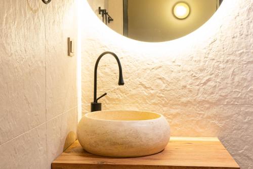 a bathroom with a stone sink and a mirror at Tare Houses in Istanbul