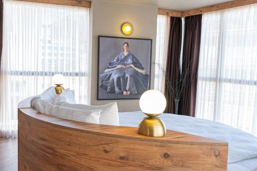 a bedroom with a large bed with a painting on the wall at Tare Houses in Istanbul