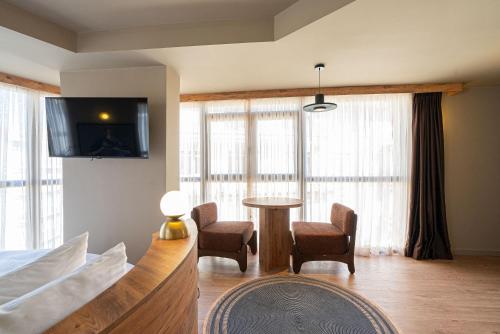 a bedroom with a table and chairs and a tv at Tare Houses in Istanbul