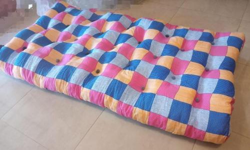 a colorful quilt laying on the floor at Frosty Heaven Guest House in Nuwara Eliya