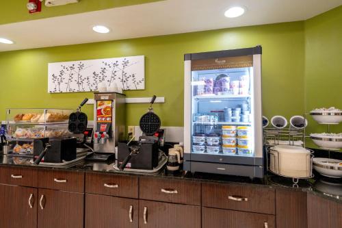 a kitchen with a refrigerator filled with food at Sleep Inn Murfreesboro Shopping District in Murfreesboro