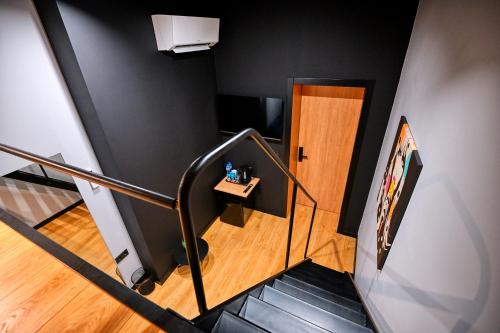 a staircase leading to a room with a door at Smart Rooms in Varna City
