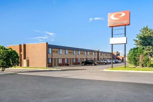 a building with a sign for a dunkin donuts at Econo Lodge Billings in Billings