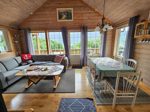a living room with a couch and a table at Øen Hytter - Hytte 2 in Sørbø