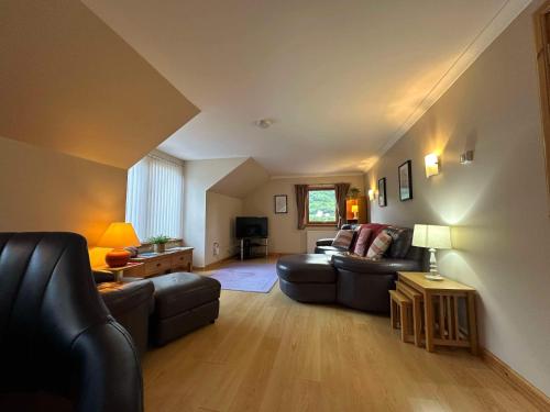 a living room with a couch and a table at The Steadings in Kinlochleven