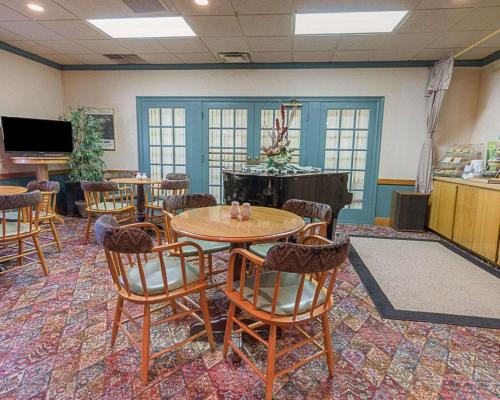 a conference room with tables and chairs and a tv at Quality Inn Ennis in Ennis
