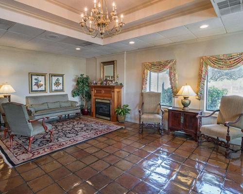 a living room with a couch and chairs and a fireplace at Quality Inn Ennis in Ennis