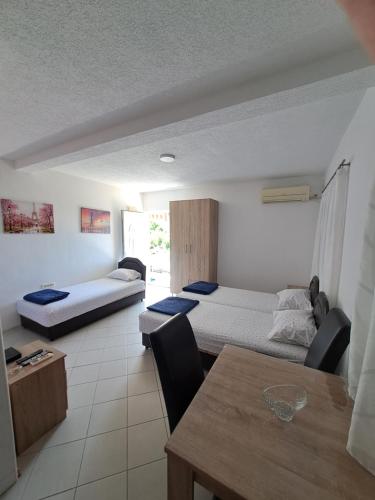 a living room with two beds and a table at Apartmani Čavor in Budva