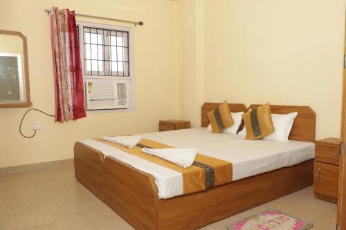 Postel nebo postele na pokoji v ubytování Vinayak Guest House