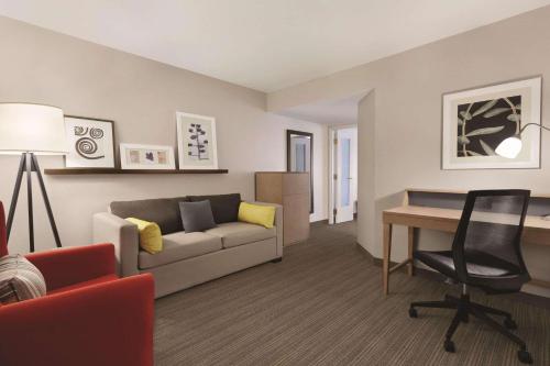 a living room with a couch and a desk at Country Inn & Suites by Radisson, Seattle-Bothell, WA in Bothell