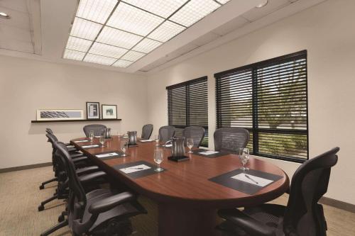 a conference room with a large wooden table and chairs at Country Inn & Suites by Radisson, Seattle-Bothell, WA in Bothell