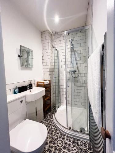 a bathroom with a shower and a toilet and a sink at Your Property Box Short Stays - Severn Street in Worcester