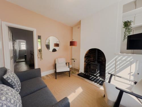 a living room with a couch and a fireplace at Your Property Box Short Stays - Severn Street in Worcester