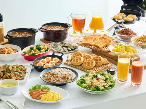 a table topped with lots of different types of food at Comfort Inn Shiojiri Kita Inter in Shiojiri