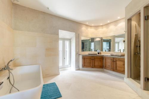 une salle de bain avec une baignoire et un lavabo dans l'établissement Oasis de Gordes, à Gordes