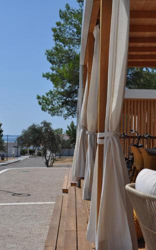 a group of umbrellas sitting on a patio at SEA HOUSE mobile home, pool, bikes, SUP - PRIVILEGE POINT camping & villas in Orebić