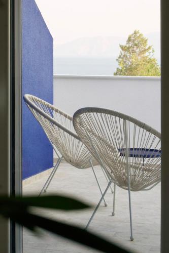 a white chair sitting in front of a window at LavandinaLuxe APP in Novi Vinodolski