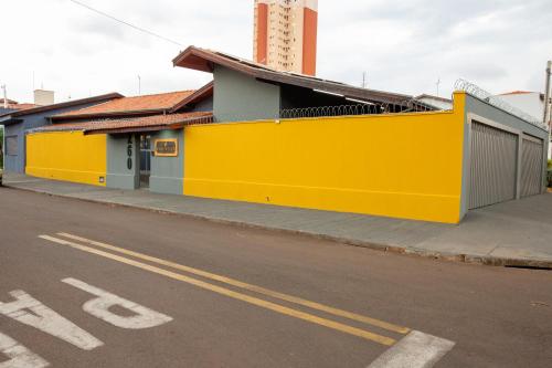 a yellow building on the side of a street at Jahu Center Village in Jaú