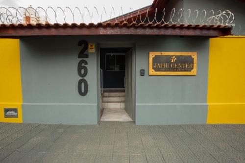 a building with a sign on the side of it at Jahu Center Village in Jaú