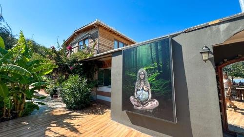 a painting of a woman on the side of a house at Gaia bungalow in Ayvalık