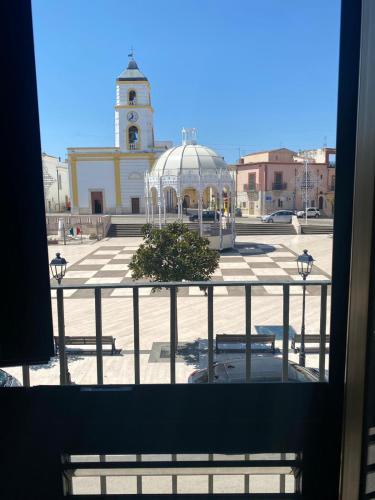 a view from a window of a building with a clock tower at Dimora Piazza Imperiale in Poggio Imperiale