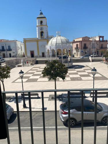 a car parked in front of a building with a clock tower at Dimora Piazza Imperiale in Poggio Imperiale