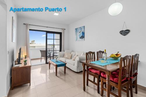 a living room with a table and a couch at Apartamentos Puerto 1, 2 y 3 in Playa Blanca