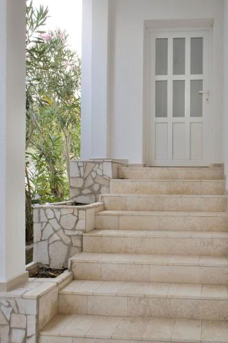 a set of stairs in front of a house with a door at LavandinaLuxe APP in Novi Vinodolski
