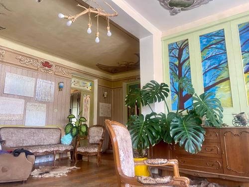a living room with a table and some plants at Vanadzor Family Art House in Vanadzor