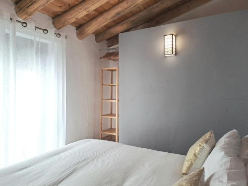 a bedroom with a white bed and a window at Noctua Estepona Old Town 025 in Estepona